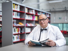 portret van Johan de Boekendokter met op de achtergrond de bibliotheek